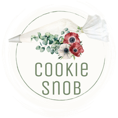 A cookie snob logo with a piping bag and flowers