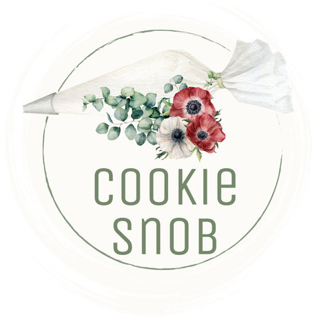 A cookie snob logo with a piping bag and flowers