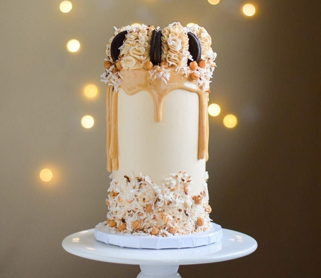 A cake is sitting on top of a white cake stand.