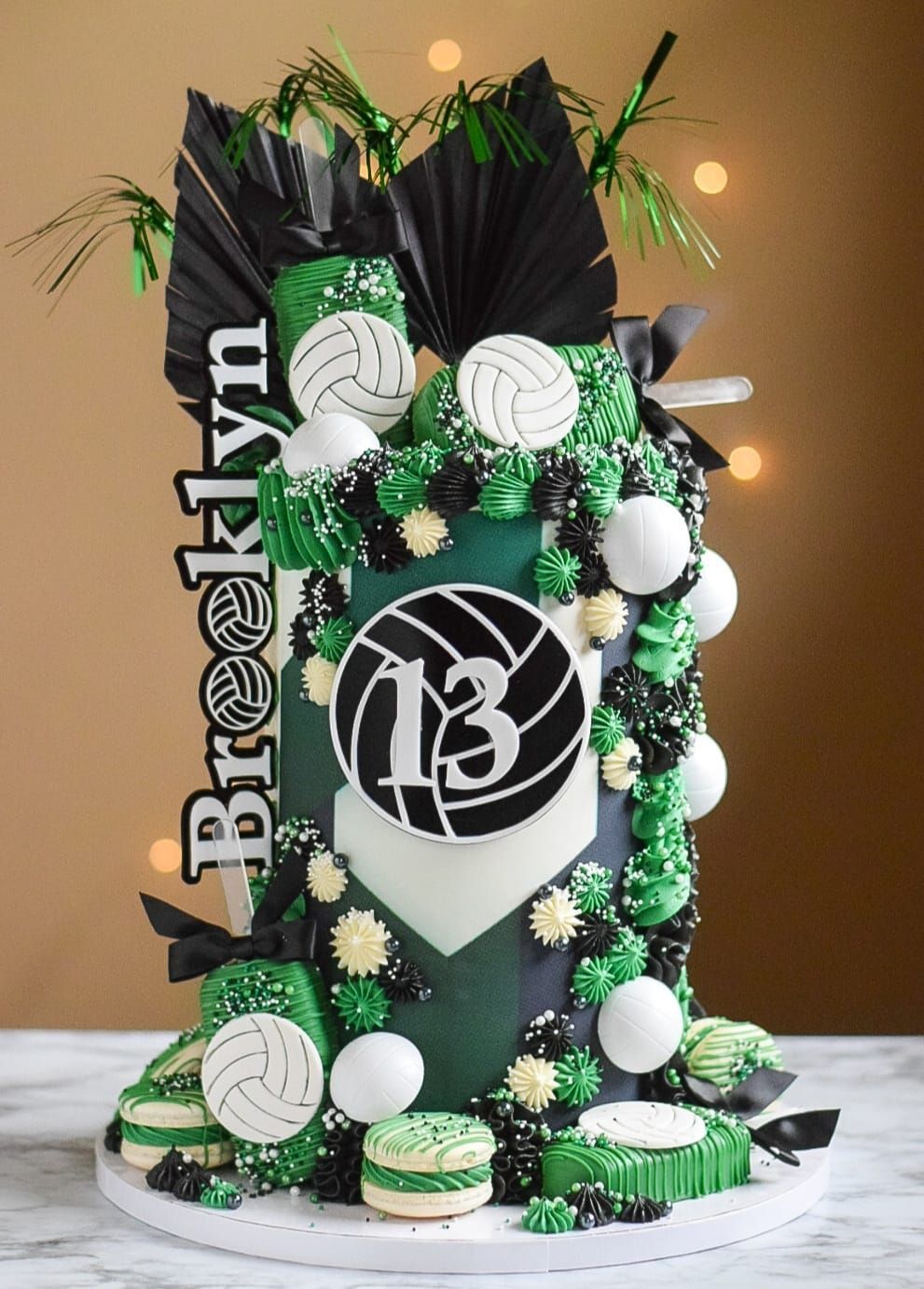 A green and black cake with the number 13 on it
