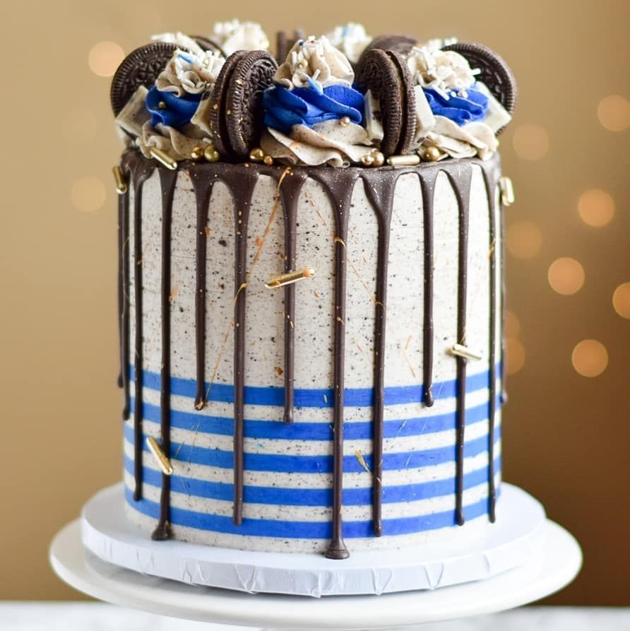 A blue and white striped cake with oreos on top
