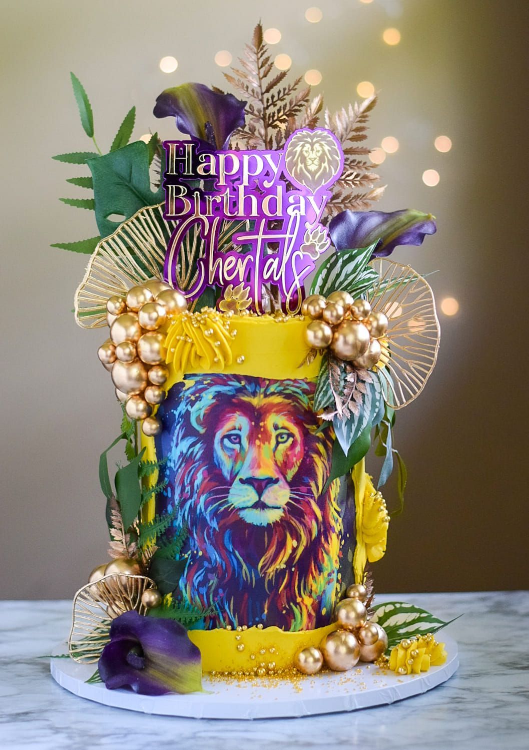 A birthday cake with a lion on it is sitting on a table.