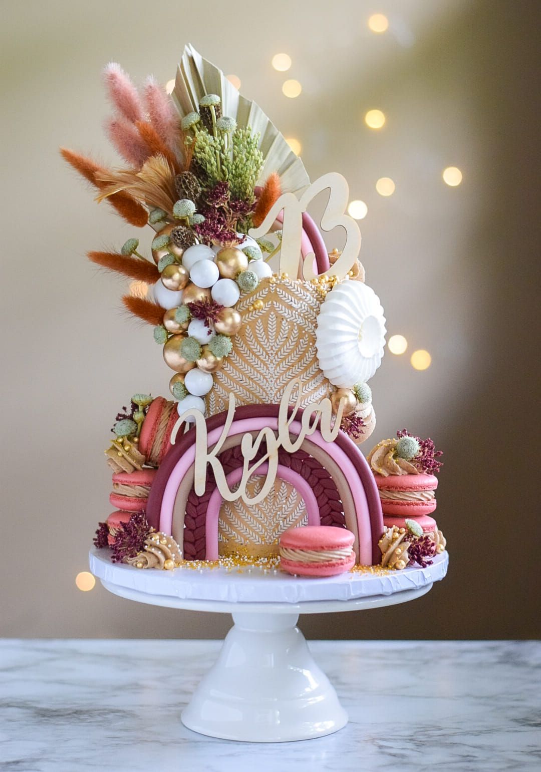A cake is sitting on top of a white cake stand on a table.
