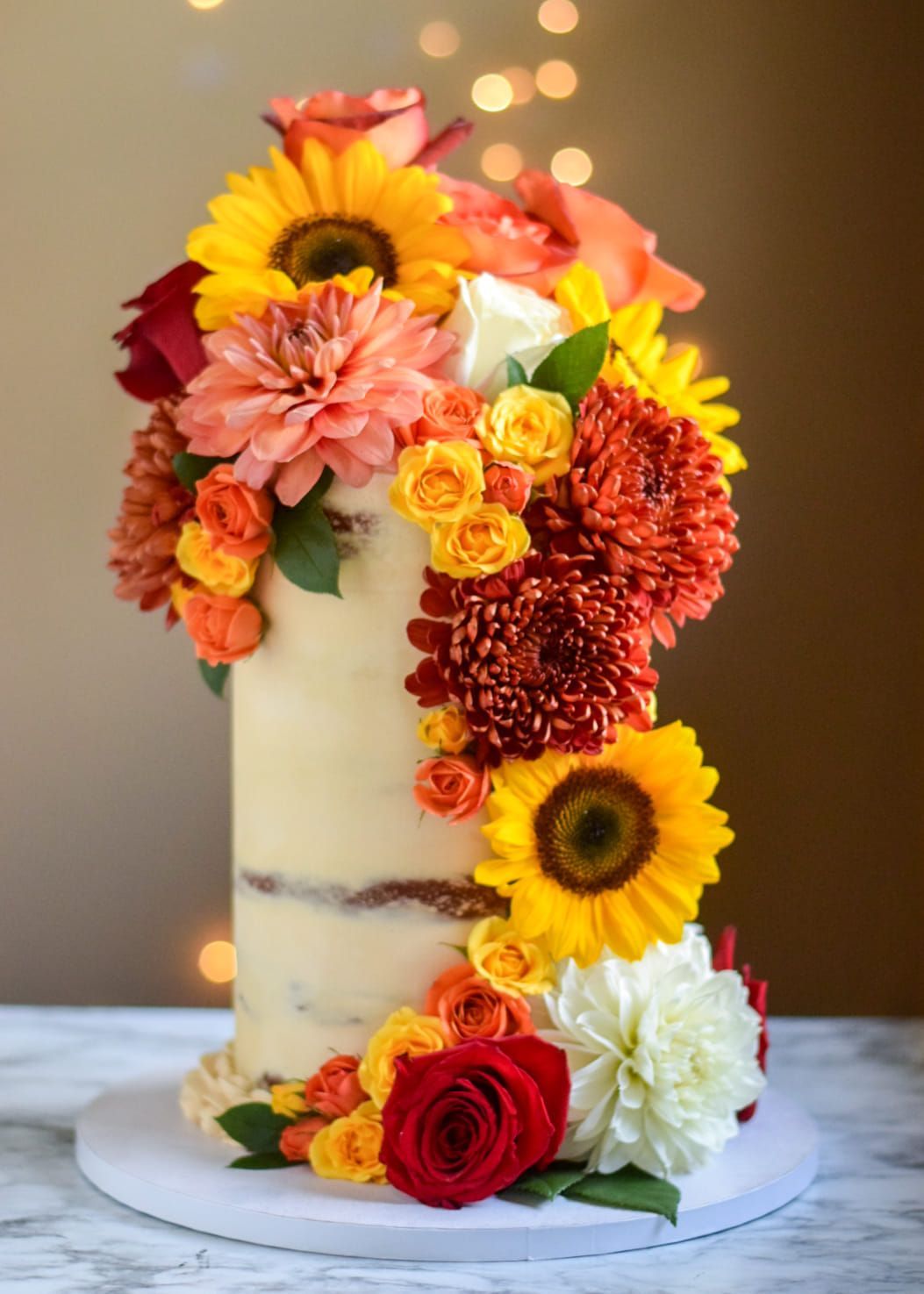 A cake with flowers on it is sitting on a table.