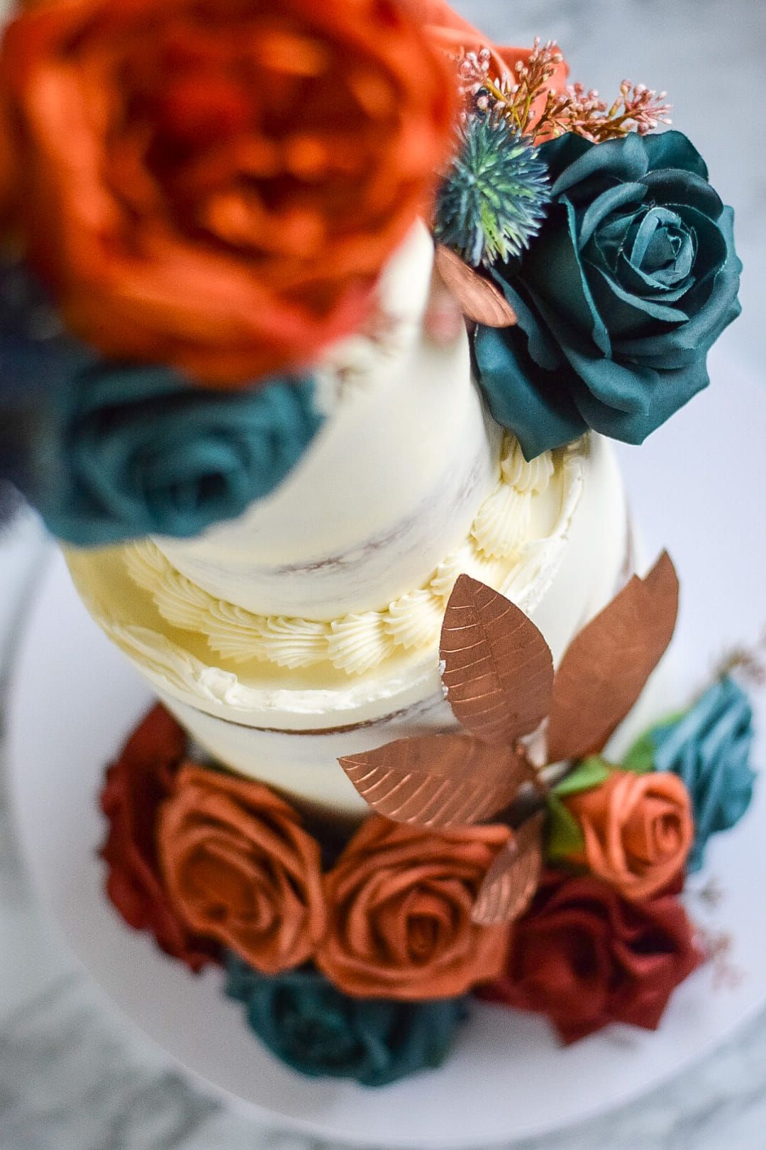 A close up of a cake with flowers on it on a table.