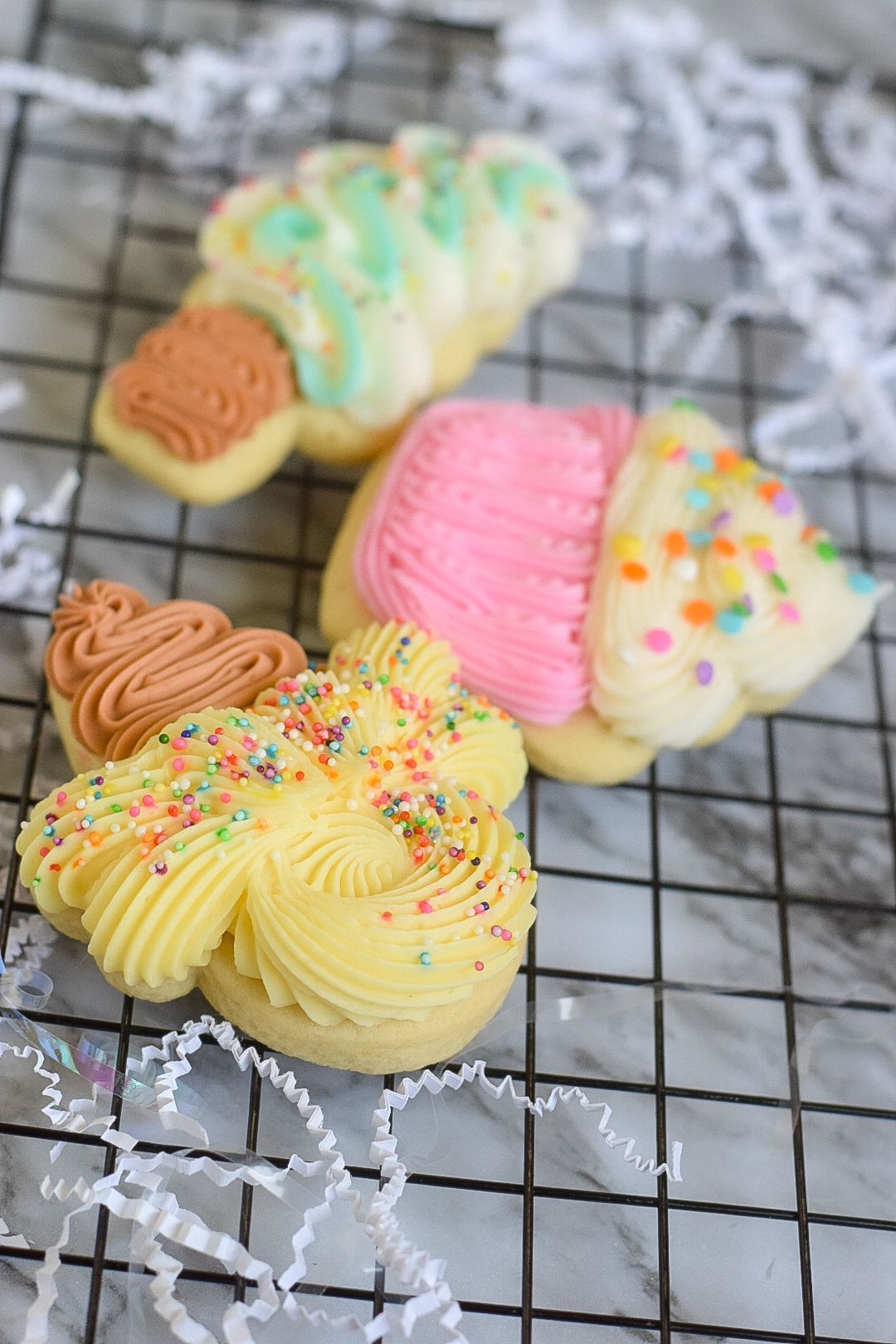 Easter cookies: Egg, carrot, bunny and round shapes with colorful frosting and sprinkles.