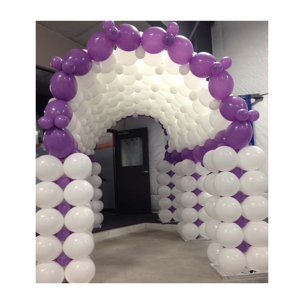 A tunnel made of white and purple balloons