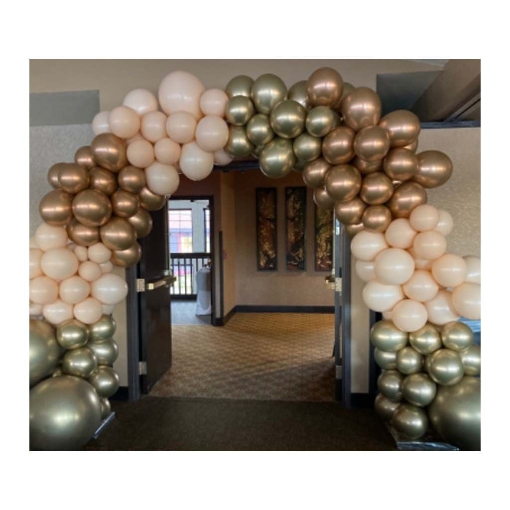 A room with a balloon arch in the middle of it