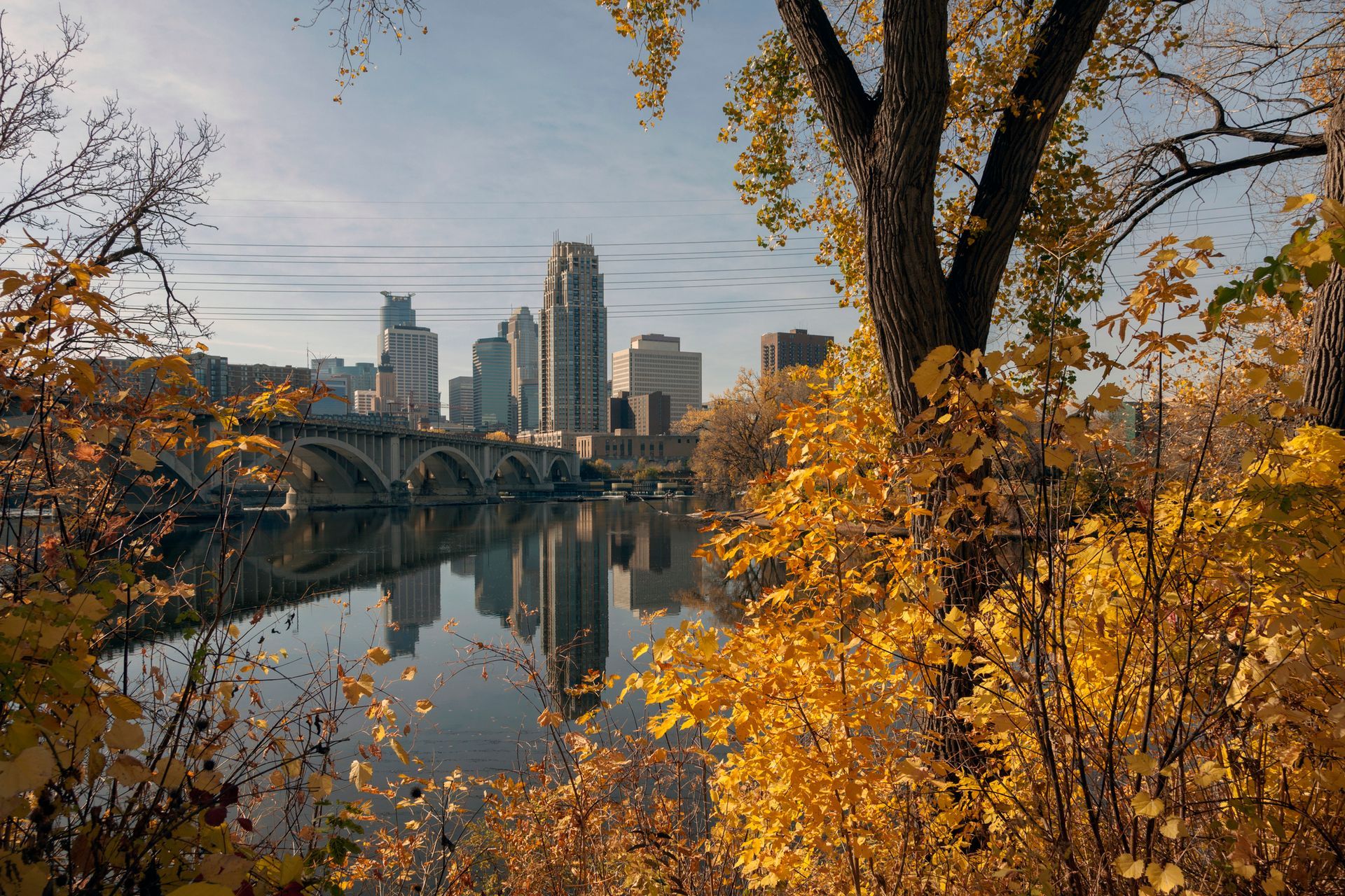 Aerial view of Little Rock, Arkansas, featuring a bridge over a river with the city skyline in the background.