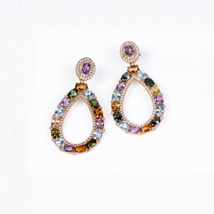 Gold plated statement earrings featuring amethyst (purple gemstones) surrounded by zirconia (clear gemstones), imperial topaz (golden-pink gemstones), tourmaline, blue and yellow topaz (golden gemstones), and garnet (red gemstones)