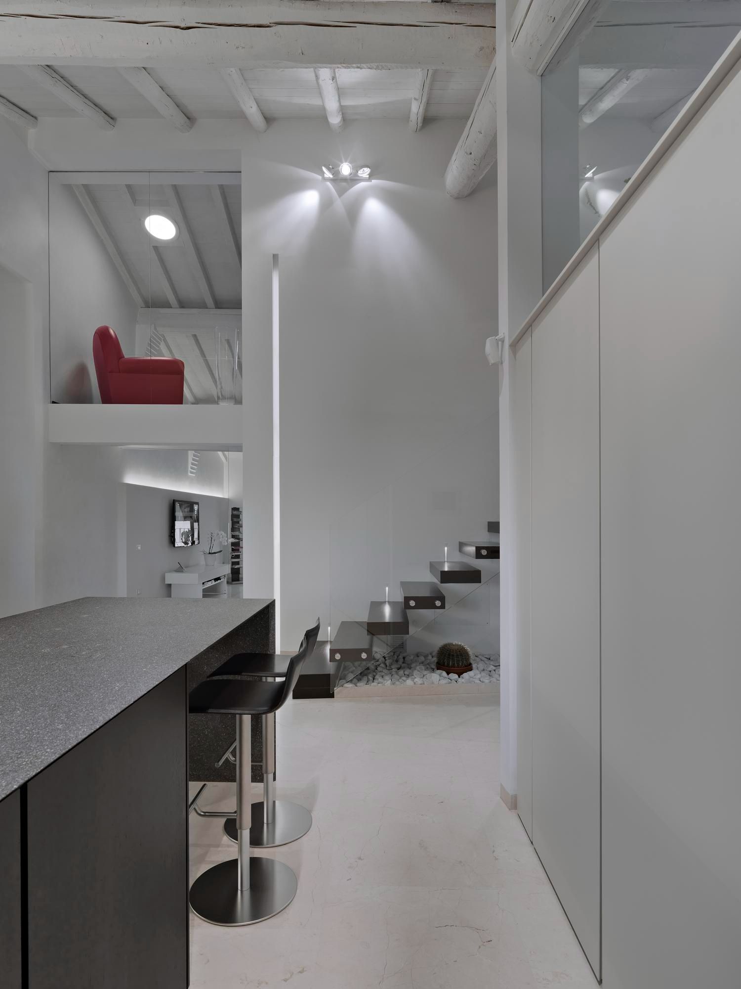 A kitchen with a red couch on the second floor