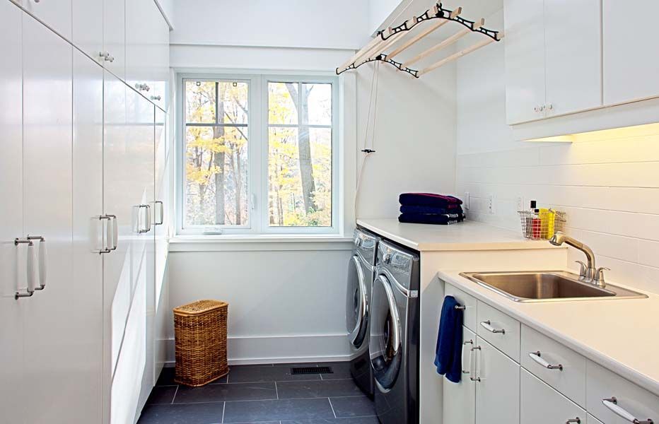 A laundry room with a washer and dryer and a sink.