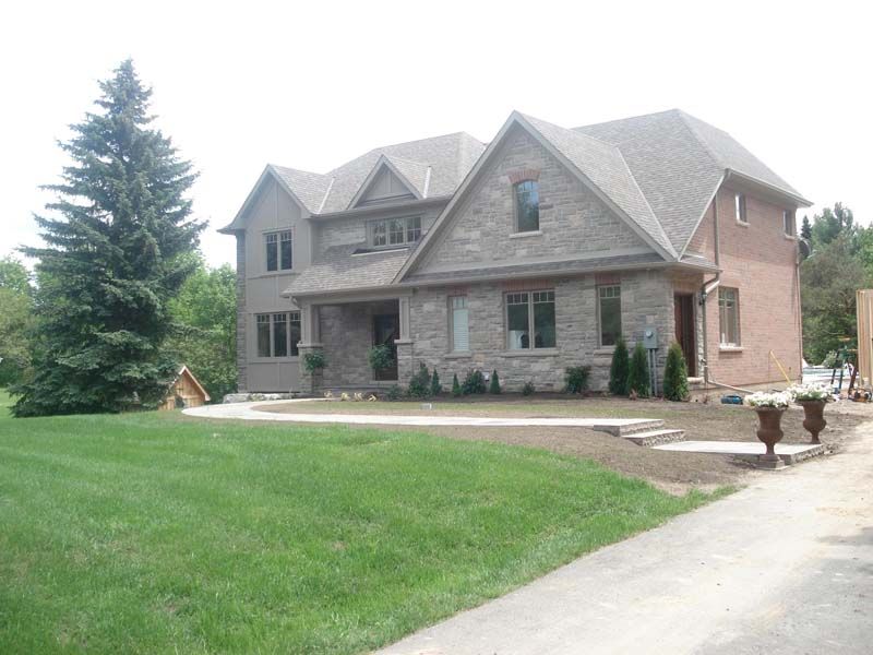 A large house with a lush green lawn in front of it