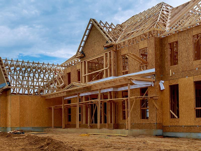 A large house is being built with a lot of wood