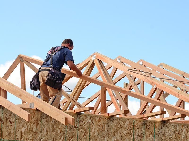 A man is standing on top of a wooden structure.