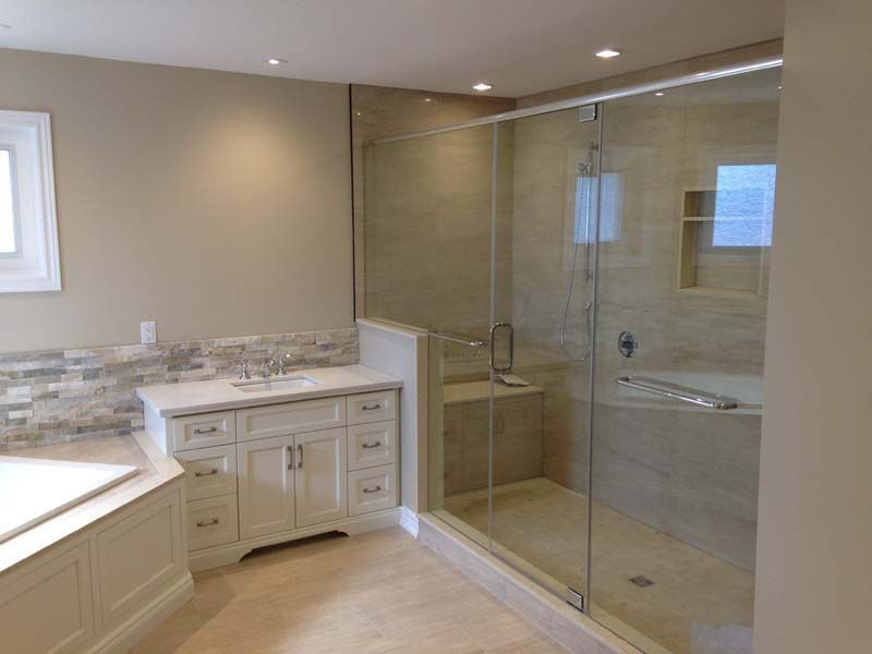 A bathroom with a walk in shower and a bathtub.