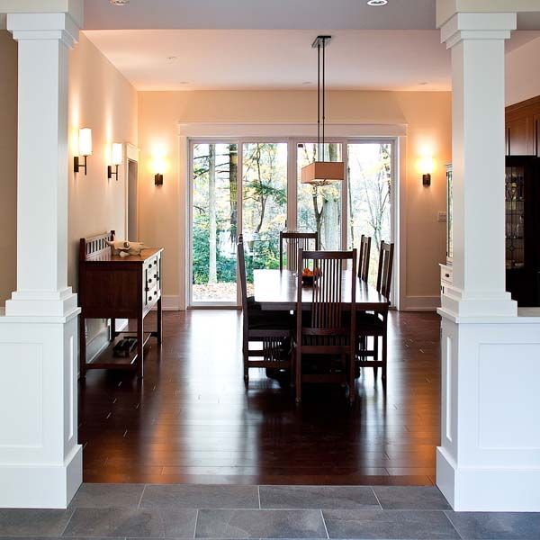 A dining room with a large table and chairs