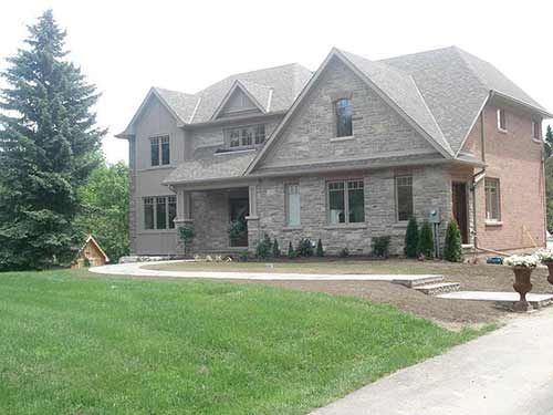 A large house with a lush green lawn in front of it