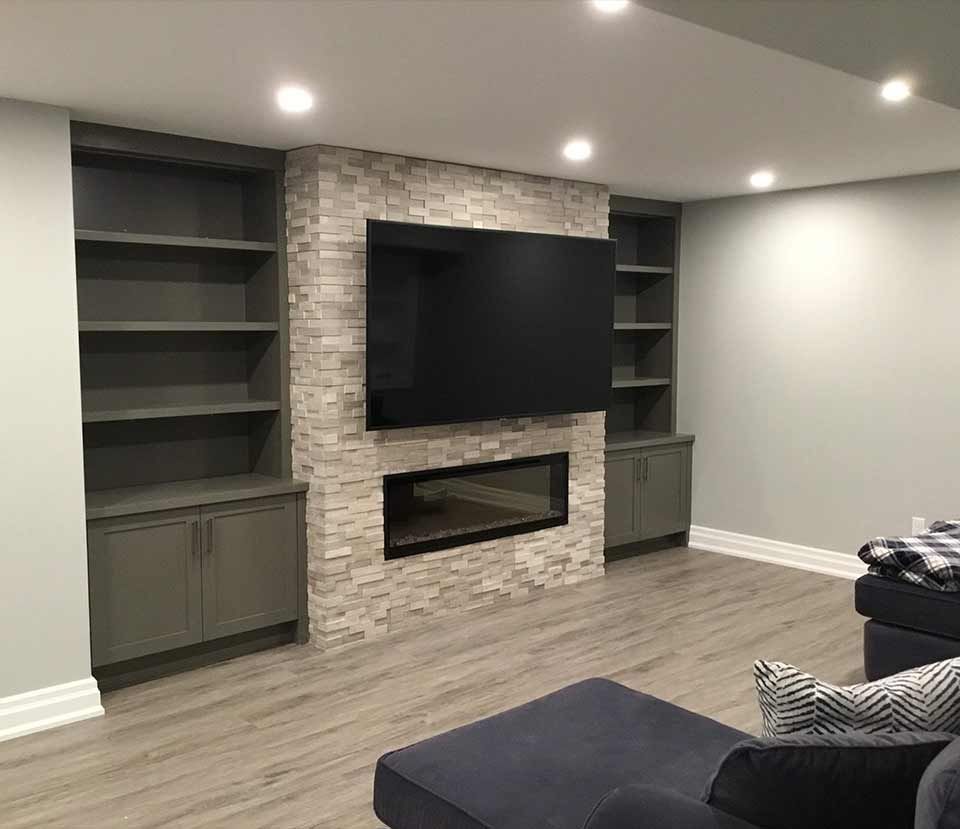 A living room with a fireplace and a flat screen tv.