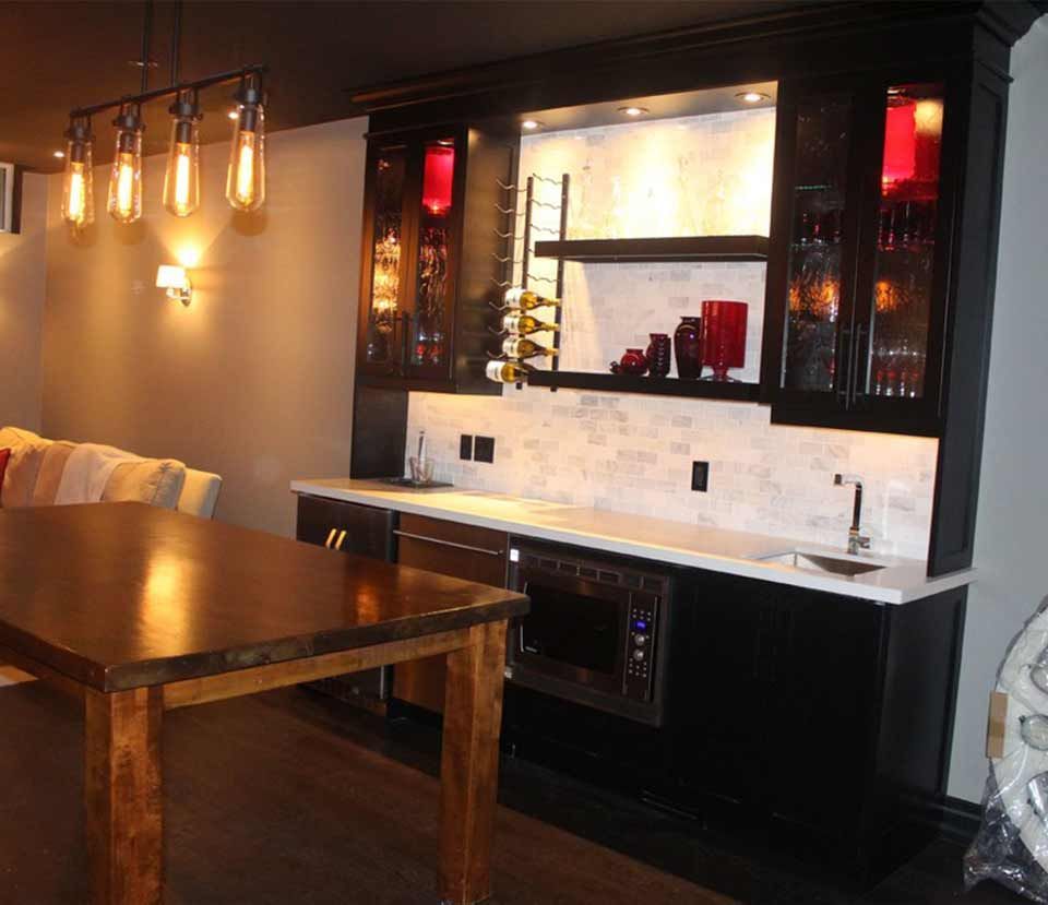 A kitchen with a table and a sink in it