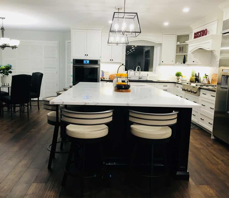 A kitchen with a large island and stools