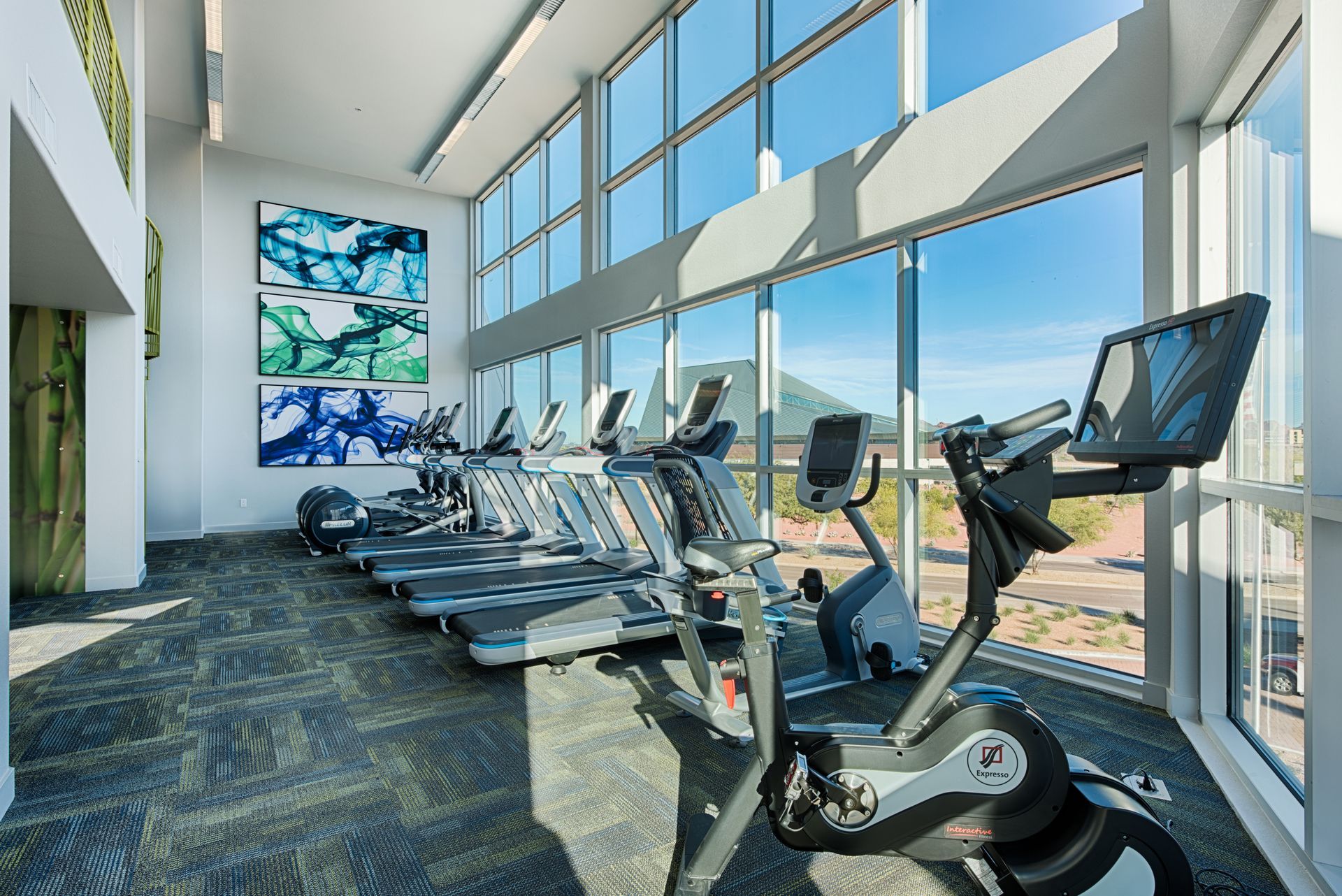 A gym with a lot of treadmills and exercise bikes.