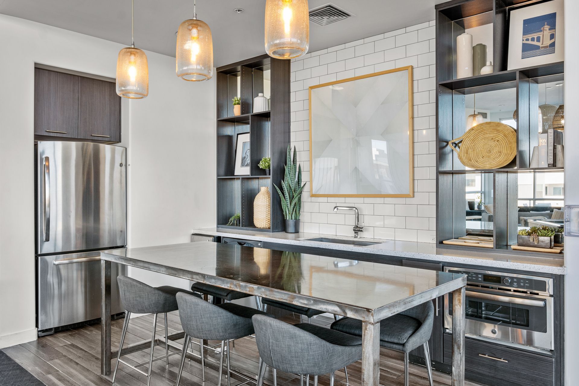 A kitchen with a table and chairs and a refrigerator.