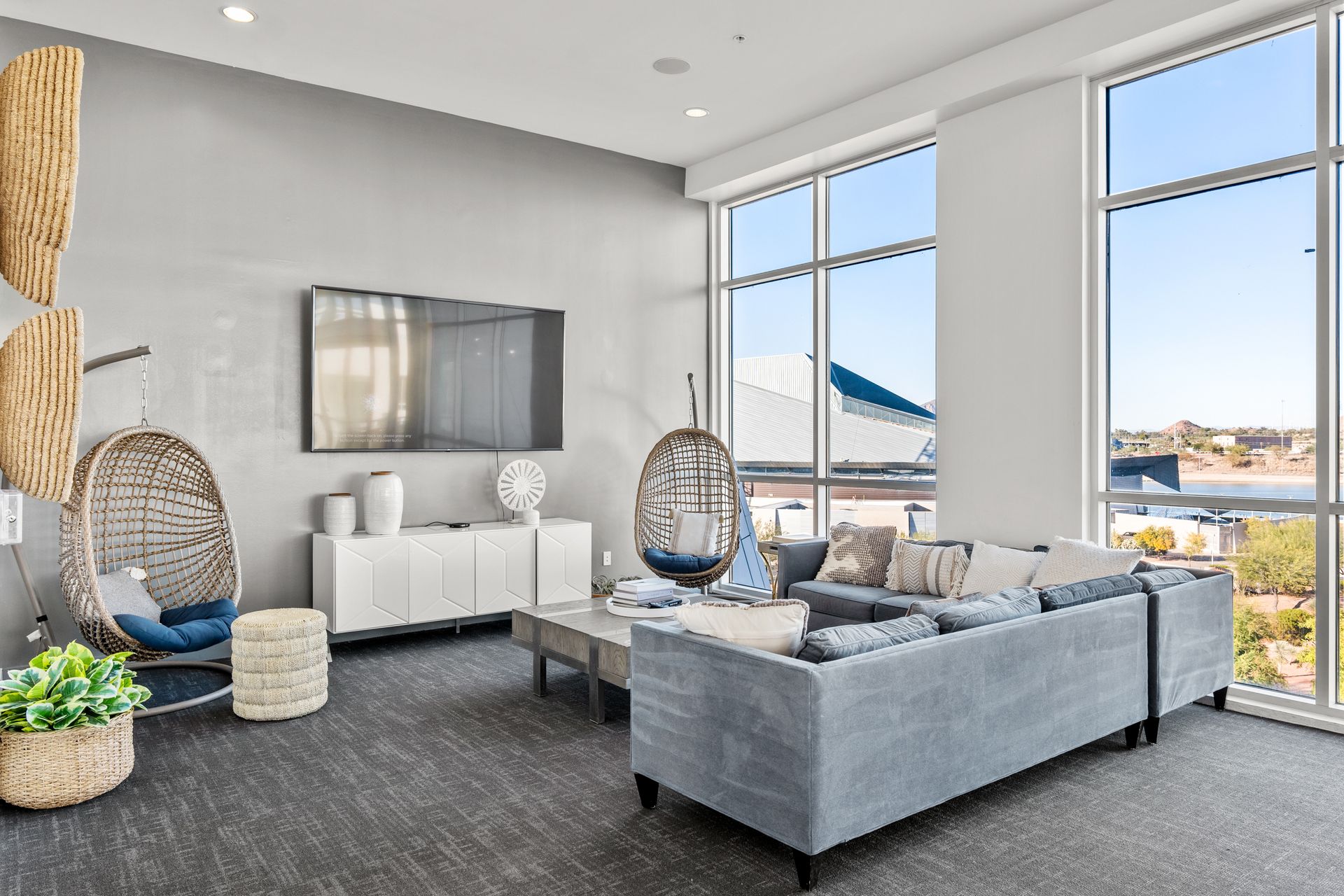 A living room with a couch , chairs , and a flat screen tv.