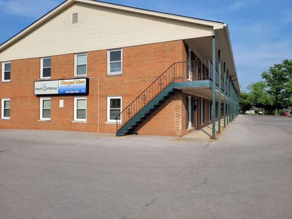 A large brick building with stairs leading up to the second floor