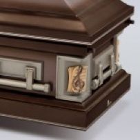 A close up of a brown coffin on a white surface.