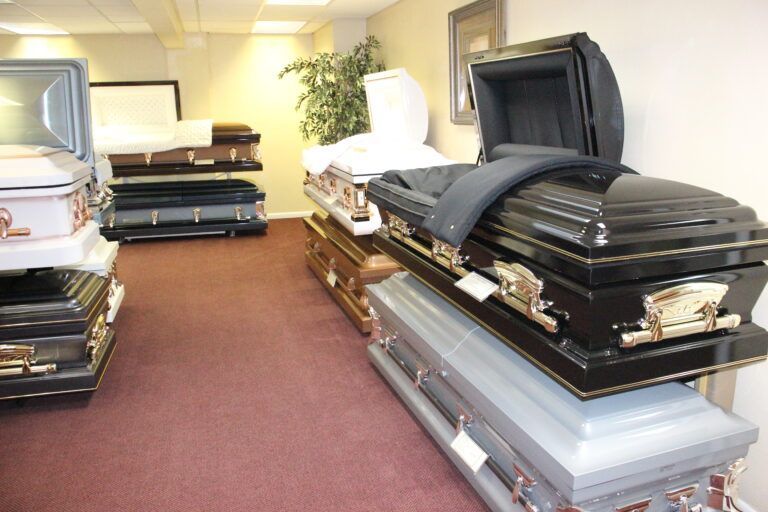 A row of coffins are stacked on top of each other in a room