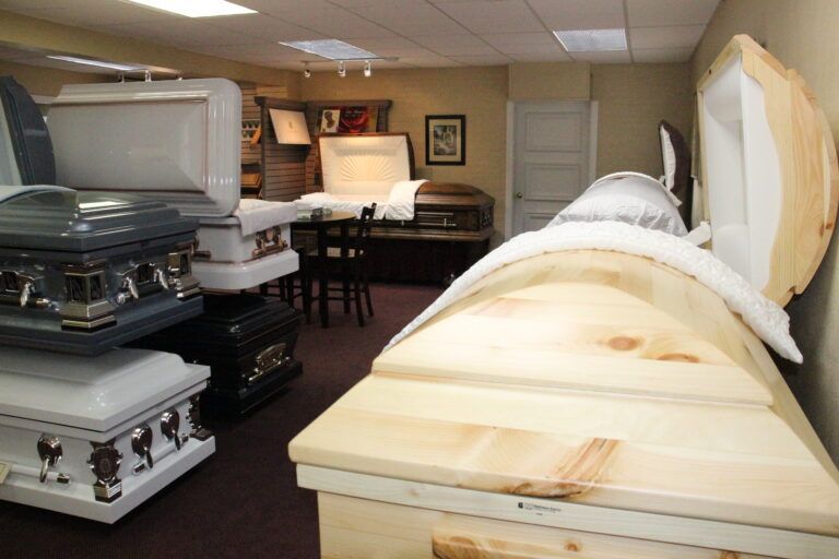 A room full of coffins including one that is open