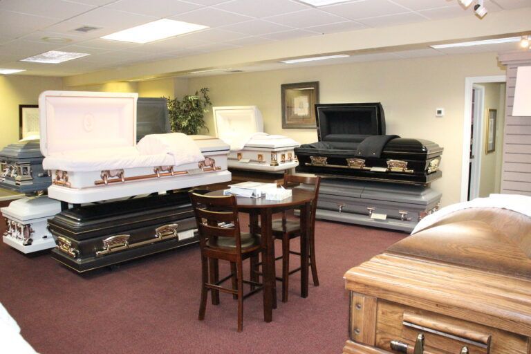 A room filled with coffins and a table and chairs