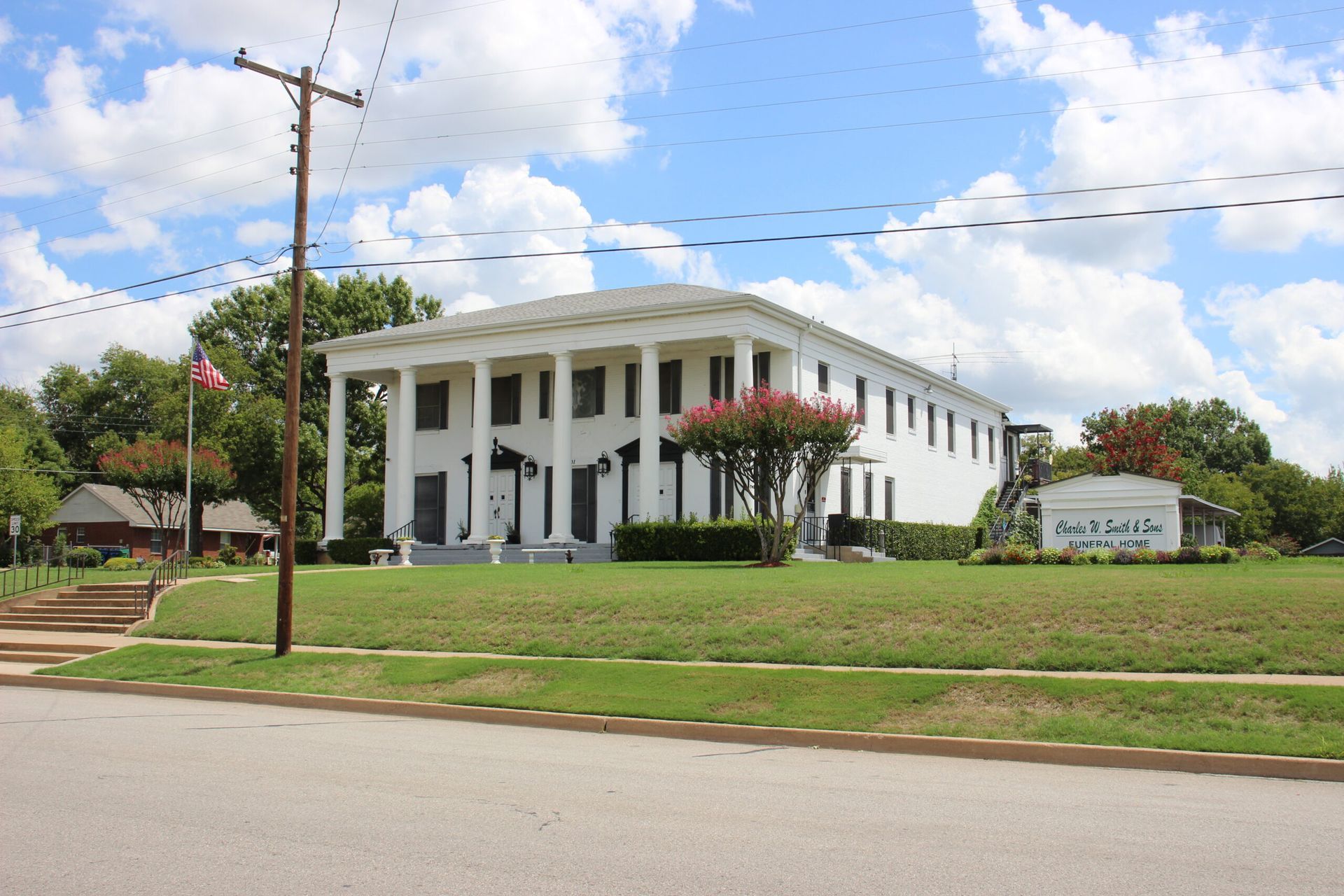 A large white building with a sign that says faith