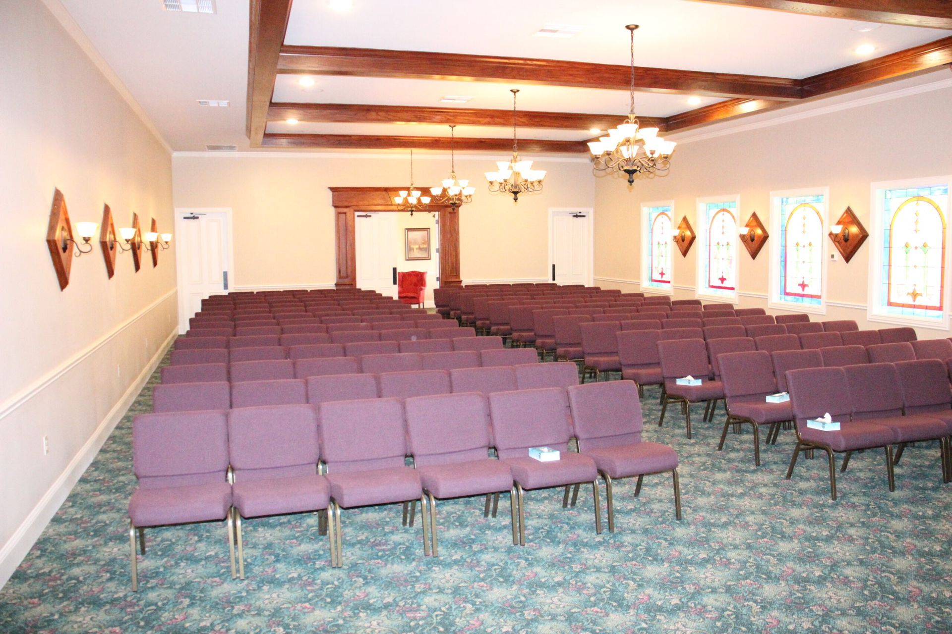 Rows of purple chairs are lined up in a large room