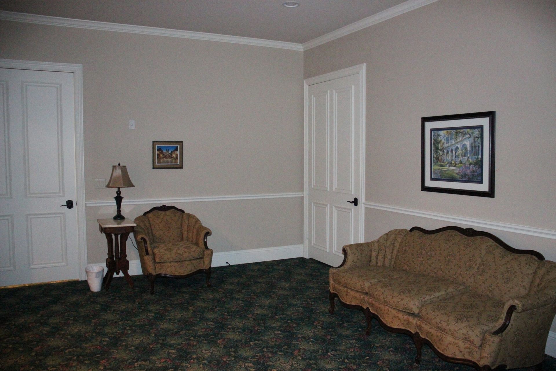 A living room with a couch and two chairs