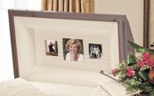 A funeral casket with three pictures of a woman on it.