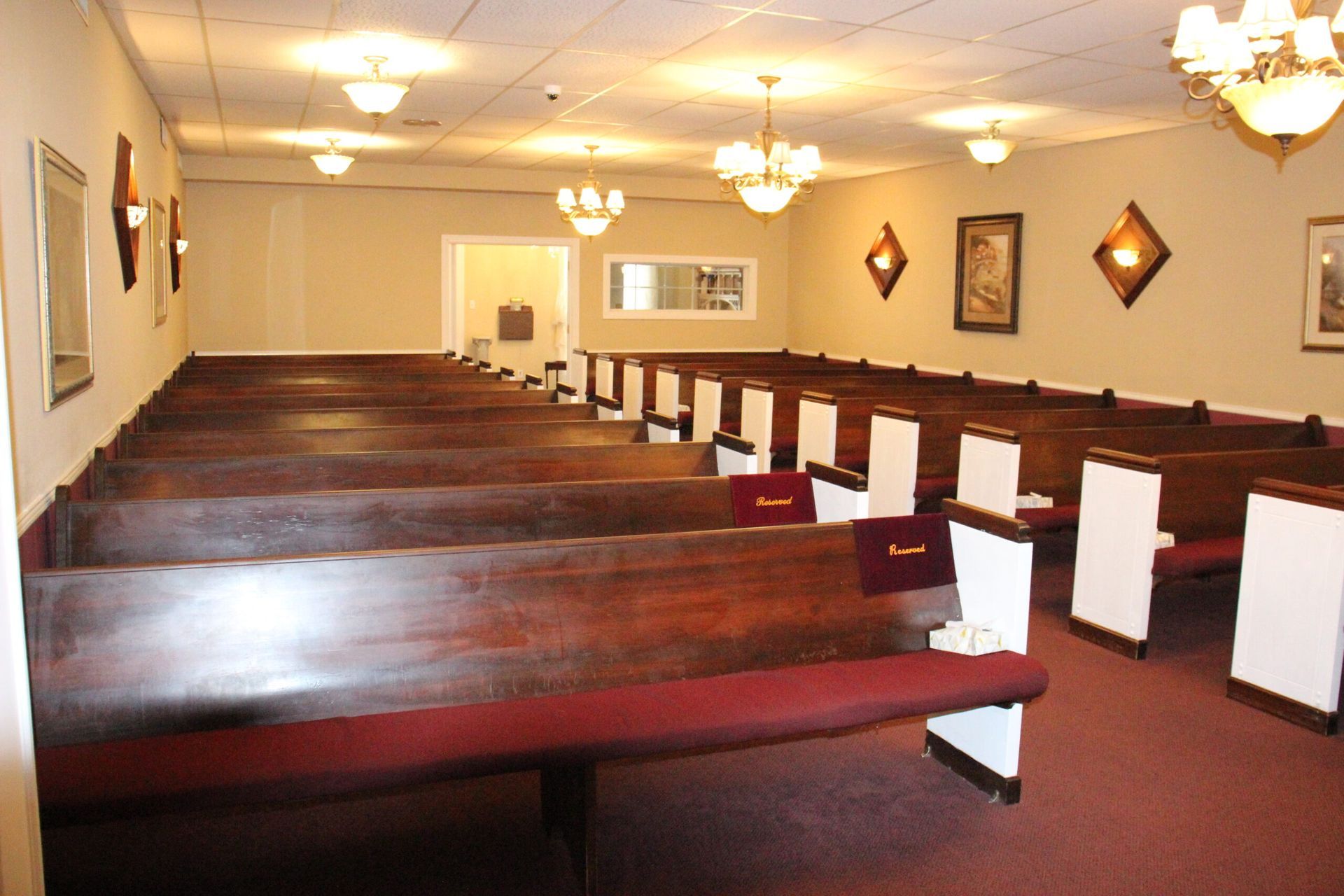 An empty church with rows of wooden benches
