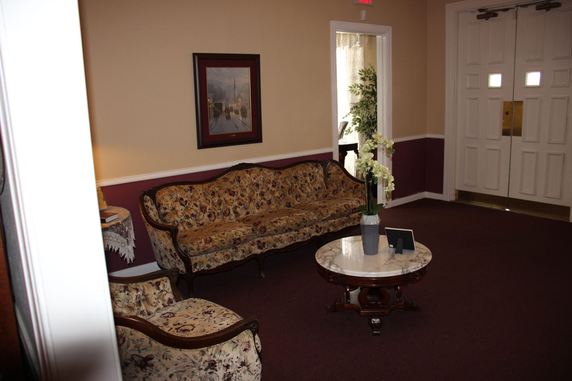 A living room with a couch , chairs , and a table.