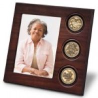 A picture of an elderly woman in a wooden frame with three coins.