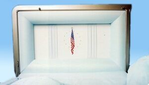 A white coffin with an american flag on it