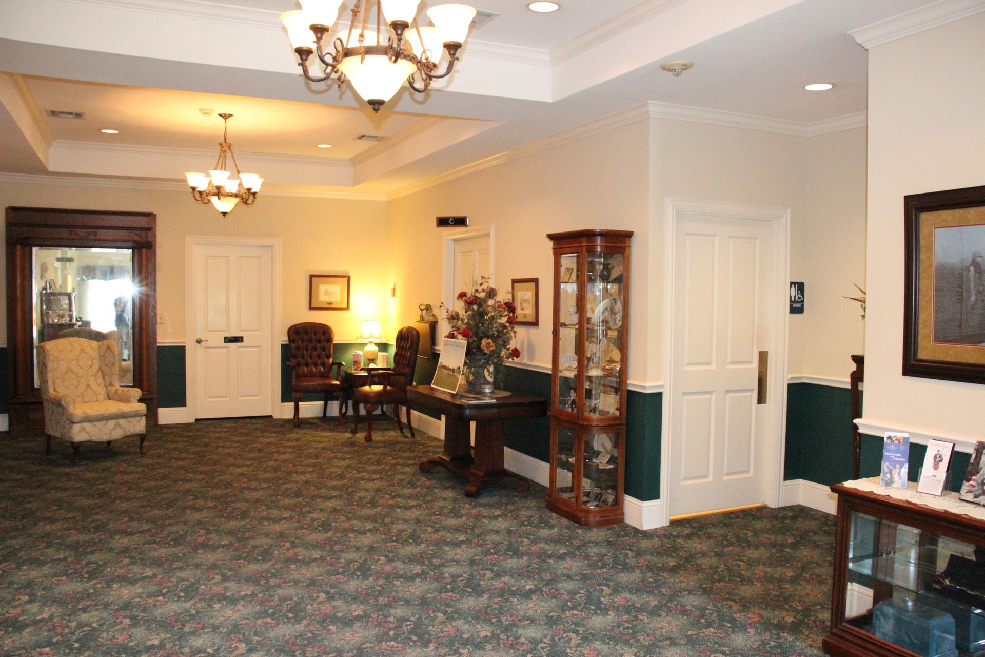 A large room with a table and chairs in it