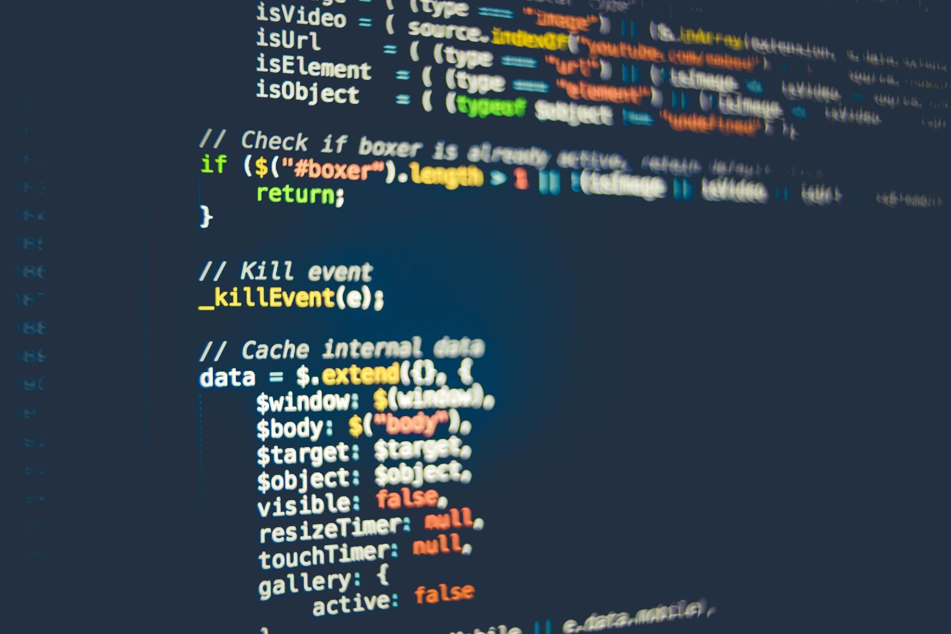 Code snippets on a dark screen, possibly JavaScript. Various functions and data structures are visible.