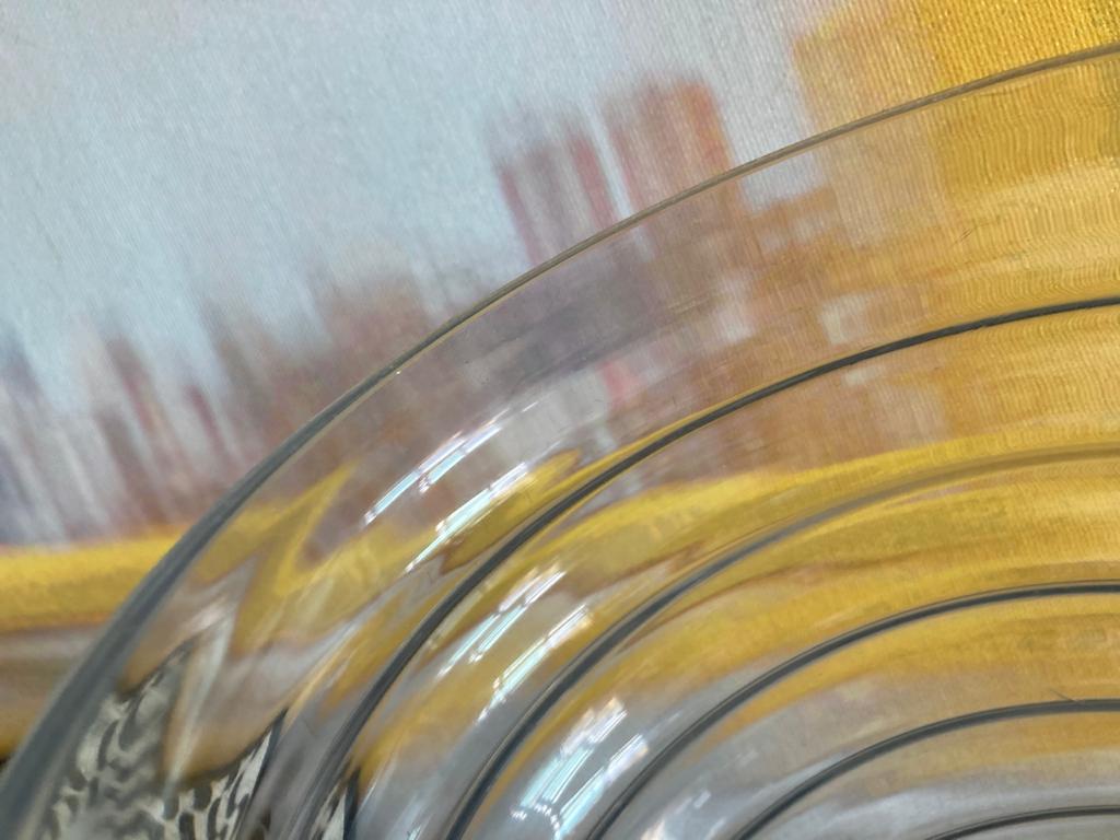 An image of a transperent cristal plate on a yellow tablecloth