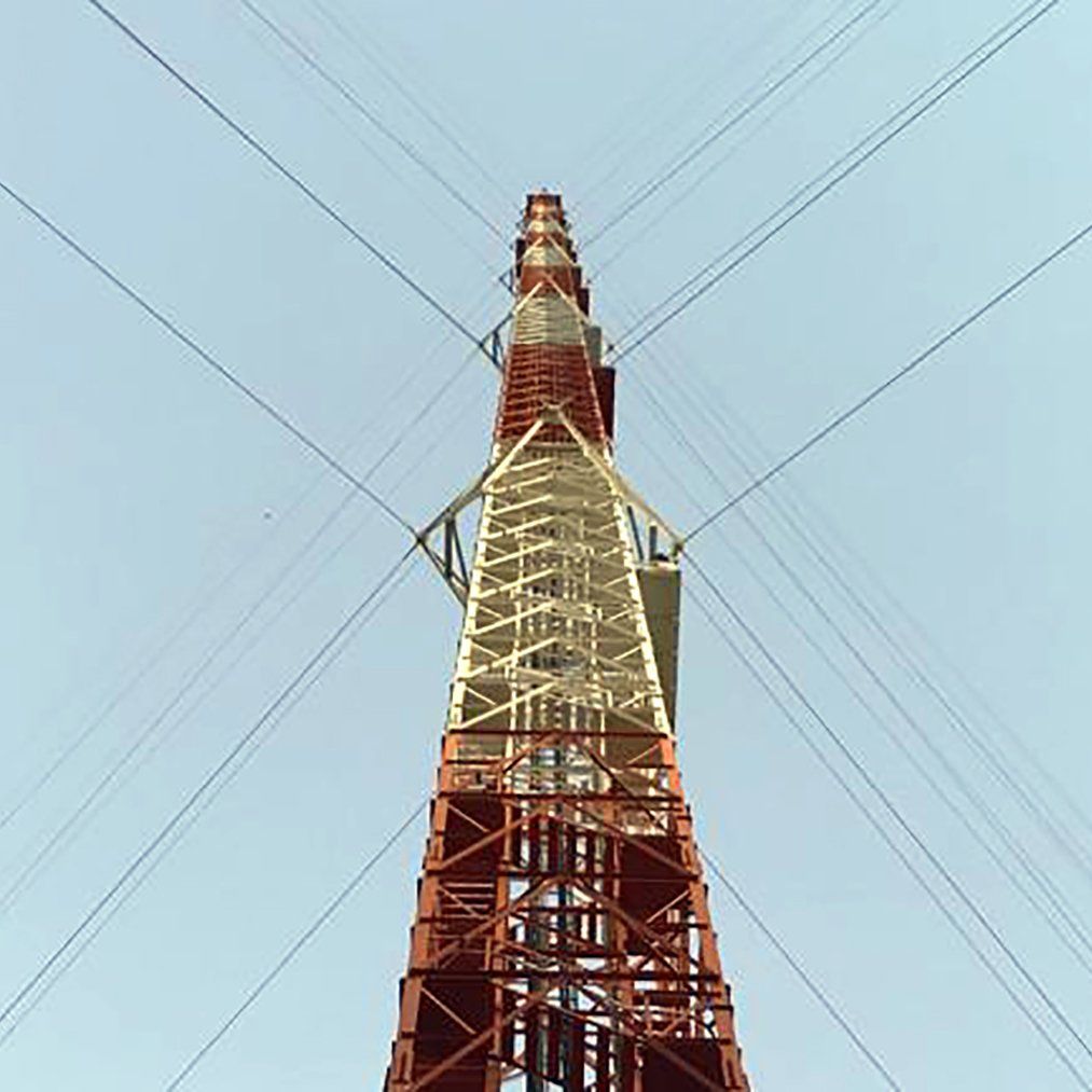 Looking up at a red and white telephone tower