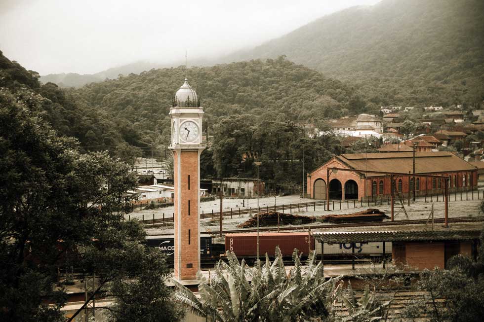 A panoramic view  of a town with brick buildings and a  watchtower
