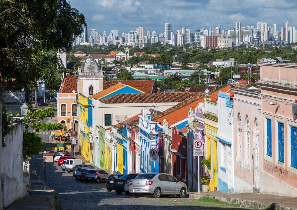 A view from the stoned street of Bom Jesus with colorful buildings and palm trees
