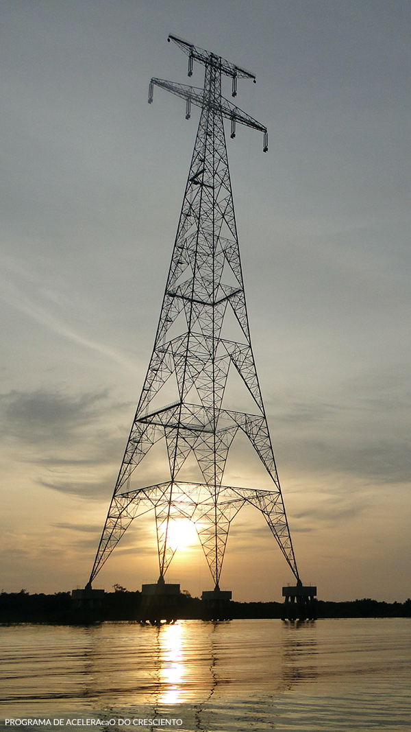 A transmission line tower in Roraima stands over a river