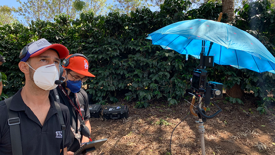 Drone operator and camera men on location in a coffee farm in rural Brazil