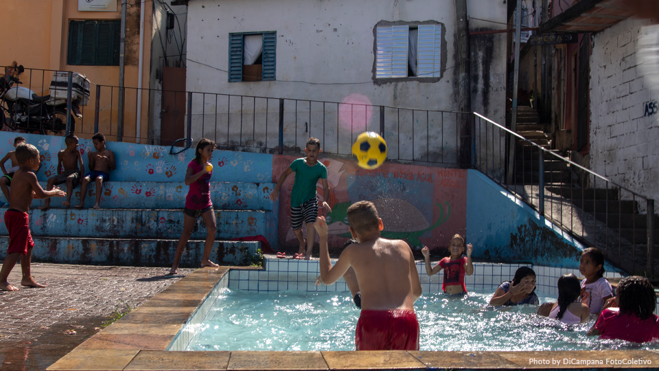 Children swim and play in a pool